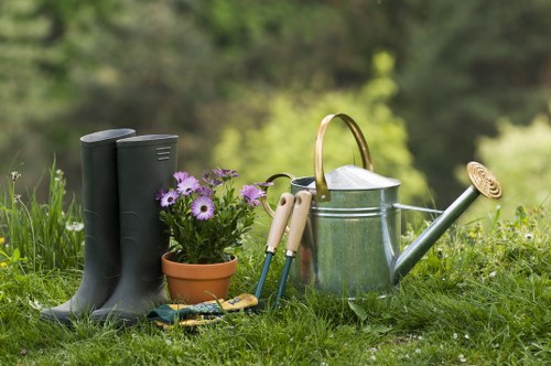 Gardener preparing tools beside a Whitechapel garden pathway